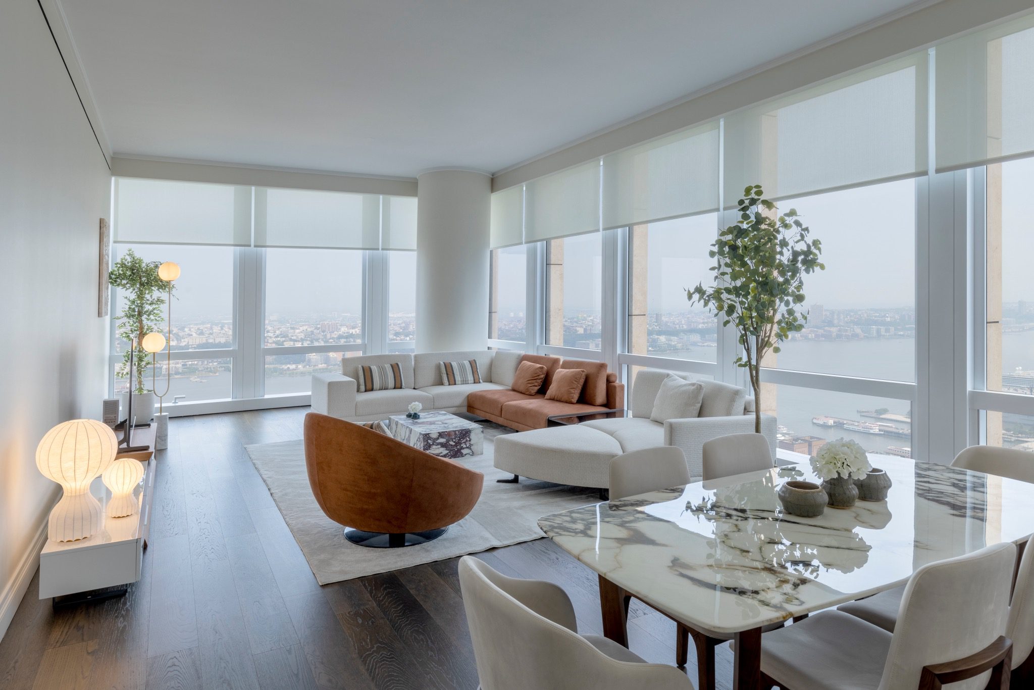 Bright modern living room with large windows and neutral furniture